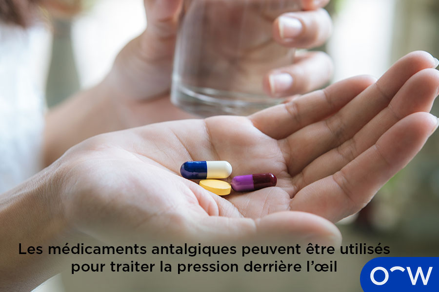Une personne tenant des comprimés de médicaments antalgiques