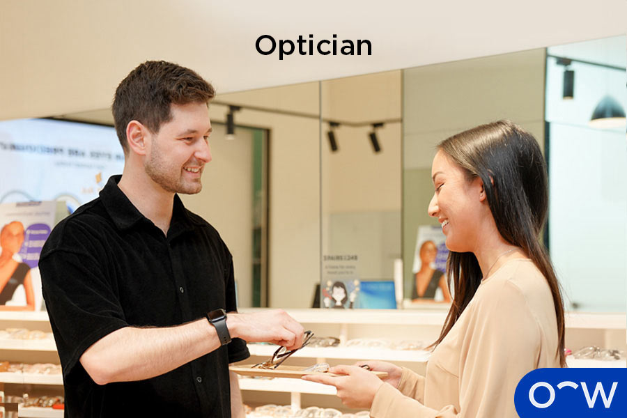 An optician assisting a customer with their new prescription glasses.
