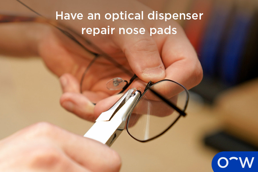 An optical dispenser repairing nose pads on a pair of glasses.