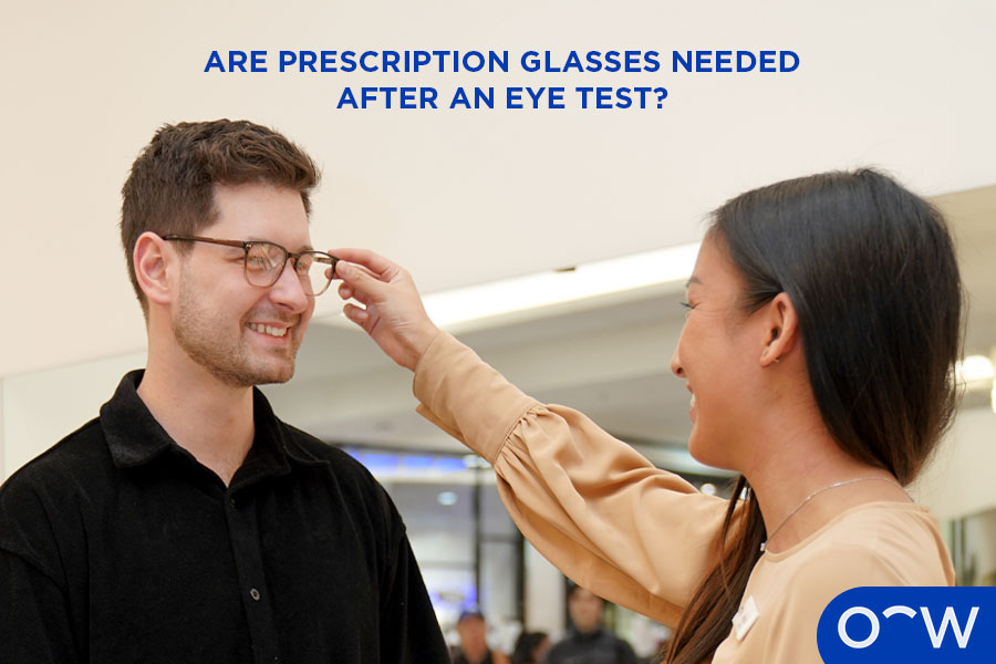 A person selecting prescription glasses after getting an eye exam with an optometrist.