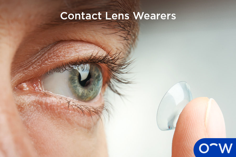 A person inserting a contact lens in