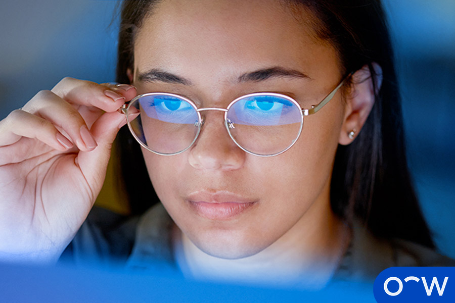 A person looking at blue light from a device.