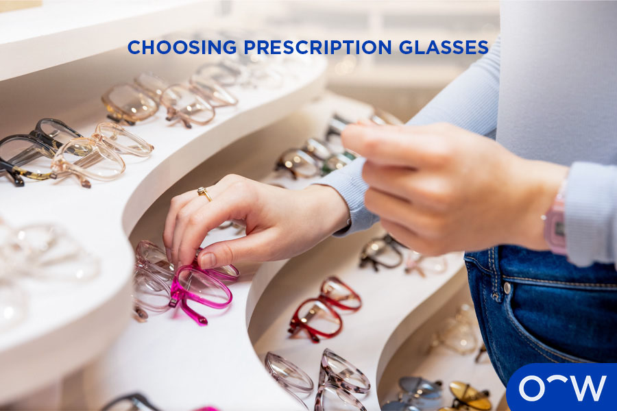 A person picking up a pair of frames in an Oscar Wylee store.