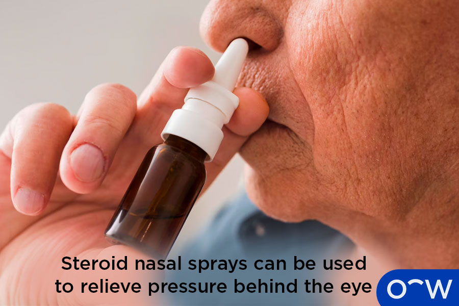 A person using a steroid nasal spray