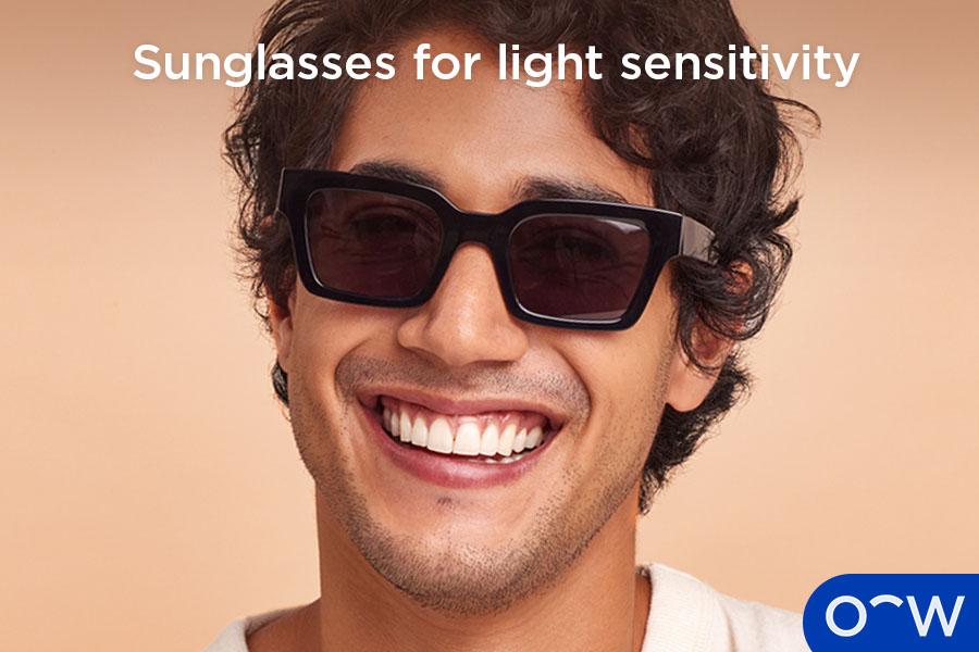 A person wearing sunglasses to protect the eyes from light during a period of light sensitivity.