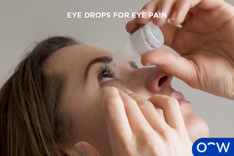 Image displaying a person lying down with eye drops held over their face.