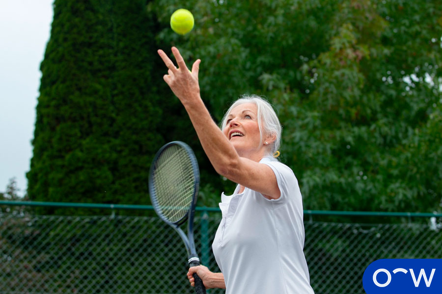 An older woman playing tennis