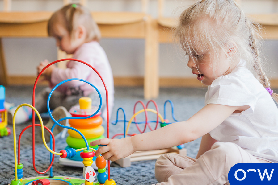 Image of a toddler playing with a bead maze