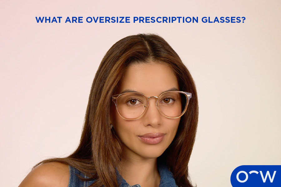 A woman posing wearing a pair of oversized, clear, square, round glasses