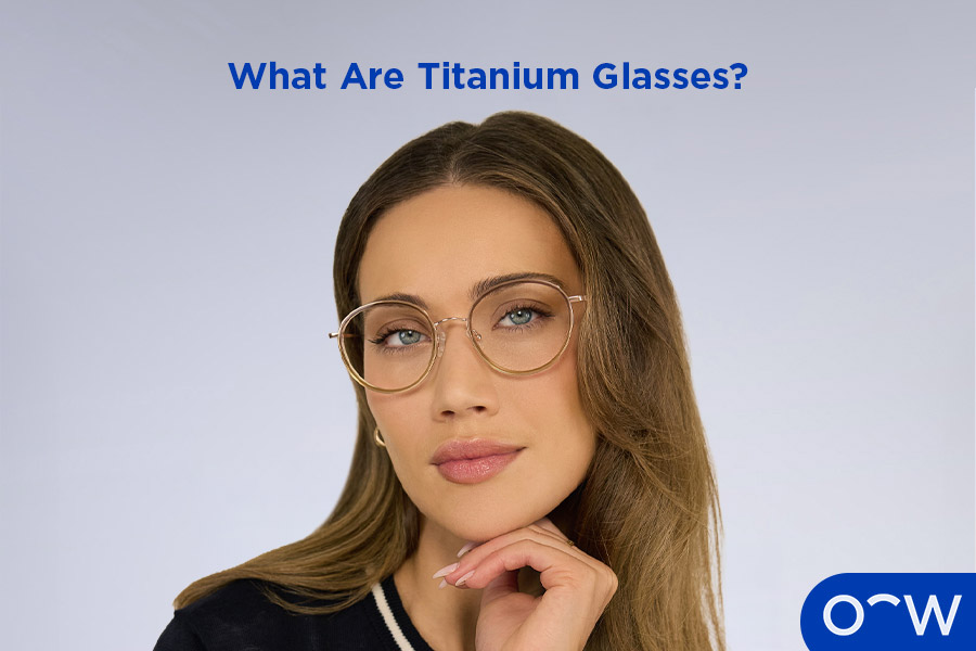 An image of a man posing slightly to the right, wearing square round titanium glasses.
