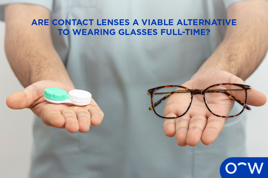 A person holding contact lenses and a pair of glasses.